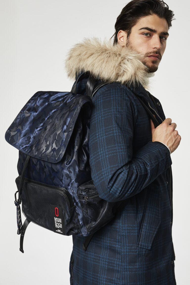 Gaudì Menswear FW20 lookbook detail: navy check parka with fur hood and blue camouflage backpack – Leonardo Del Paggio, menswear designer